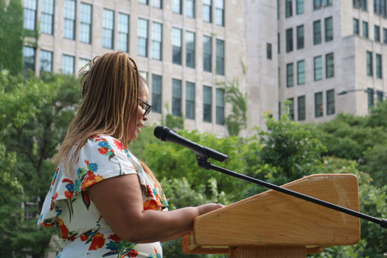 A woman giving a speech in a park about her stroke in Chicago
